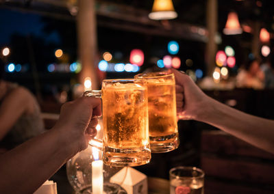 Close-up of hand holding beer glass