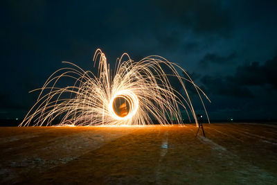 Illuminated wire wool against sky at night