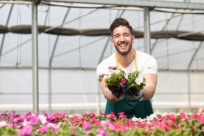 Happy boy working in greenhouse