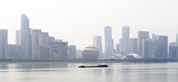 View of buildings in city against clear sky