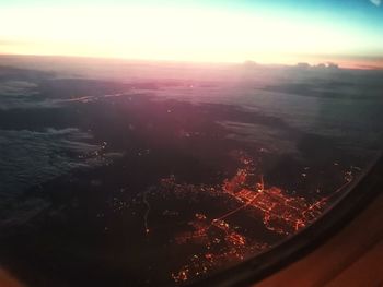 Aerial view of cityscape against sky during sunset