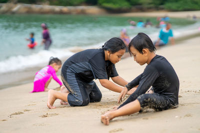 Rear view of people on beach