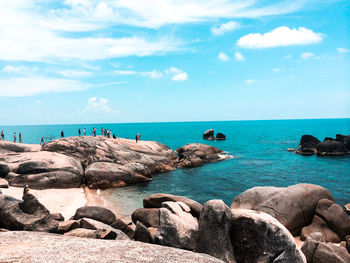 Rocks on beach against sky