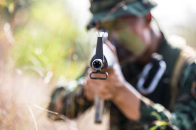 Close-up of army soldier shooting with rifle