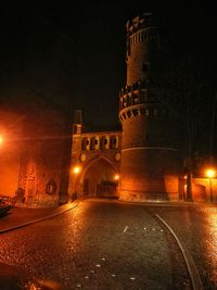 Low angle view of illuminated clock tower at night