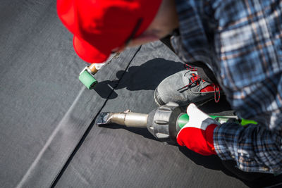 Midsection of man repairing car