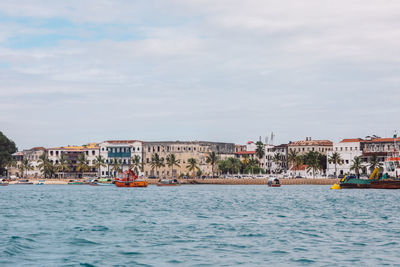 Boats in sea against sky