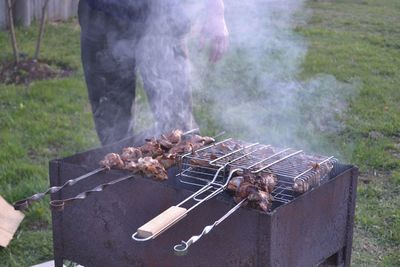 Meat on barbecue grill in backyard