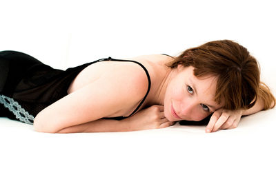 Close-up portrait of woman against white background