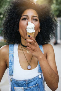 Close-up of woman licking ice cream