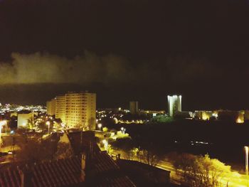 High angle view of buildings in city at night