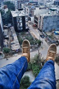 Low section of man standing on floor in city