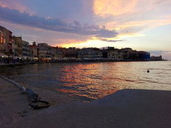 Scenic view of river against sky at sunset