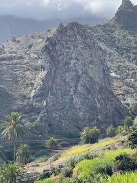 Scenic view of land and mountains against sky