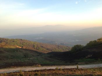 Scenic view of mountains against sky at sunset