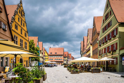 Street amidst buildings in town against sky