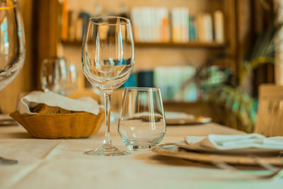 Close-up of glasses and plates on table