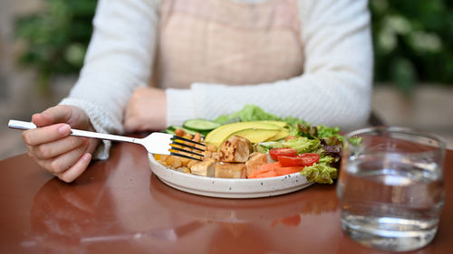 Midsection of woman having food