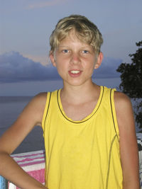 Portrait of boy on beach against sky