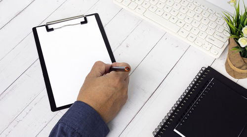 Businessman hands with pen writing notebook on office desk table with. copy space. business concept.