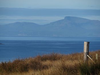 Scenic view of sea and mountains against sky