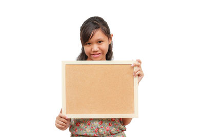 Portrait of a smiling girl standing against white background