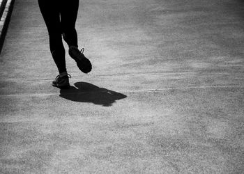 Low section of man walking on street