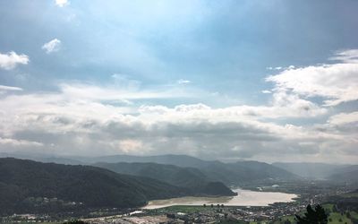 Scenic view of sea and mountains against sky