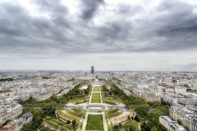 High angle view of buildings in city against cloudy sky