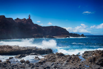 Scenic view of sea against blue sky
