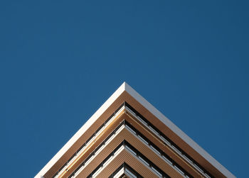 Low angle view of building against clear blue sky