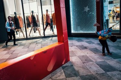 People walking on tiled floor in city