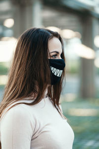 Woman wearing mask looking away