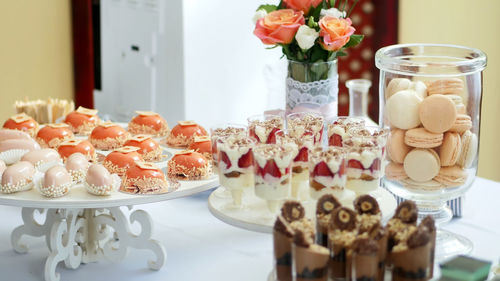 Close-up, a variety of delicious desserts, cakes with cream, strawberries, chocolate, under icing