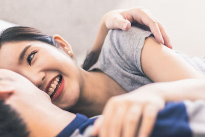 Young woman lying on bed at home