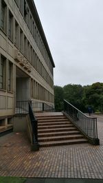 Staircase by building against sky