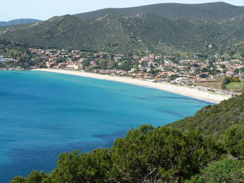 Scenic view of sea by mountains