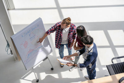 Low section of people standing on paper