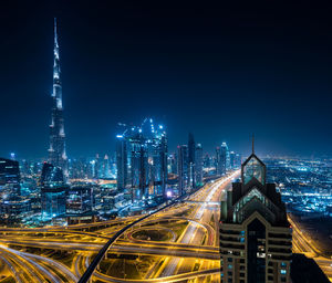 Illuminated cityscape against sky at night