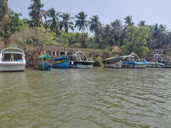 Boats moored in lake against sky