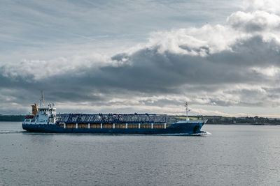 Ship sailing on sea against sky