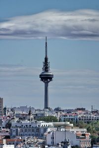 Tower amidst buildings in city against sky