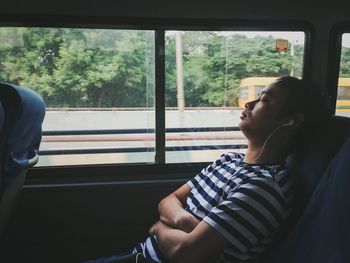 Man looking through train window