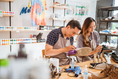 Side view of man using mobile phone while standing at restaurant