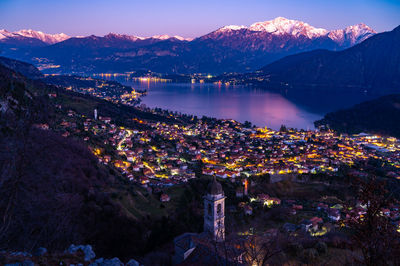 Panorama of lake como from ossuccio, and the church of the madonna del soccorso, at dusk.