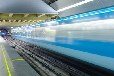 Santiago,  chile - motion blur of a subway train at metro de santiago with people waiting.