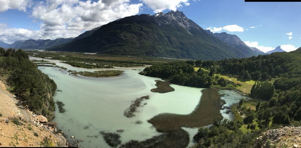 Panoramic view of river amidst mountains against sky