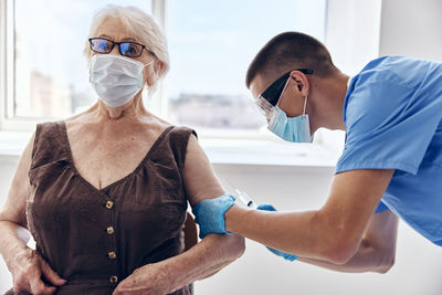 Side view of mother and daughter in clinic