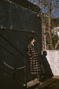 Man standing against building