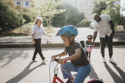 Parents and daughters spending time actively outdoors